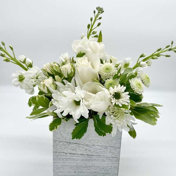 White floral arrangement in a gray square box