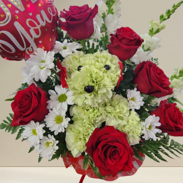Bouquet with red roses, white daisies, and a teddy bear centerpiece