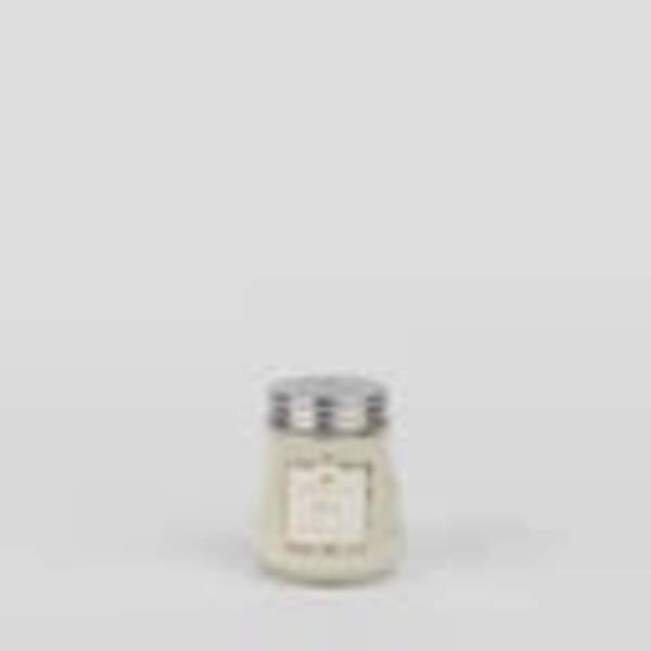Small white candle in a glass jar with a metal lid