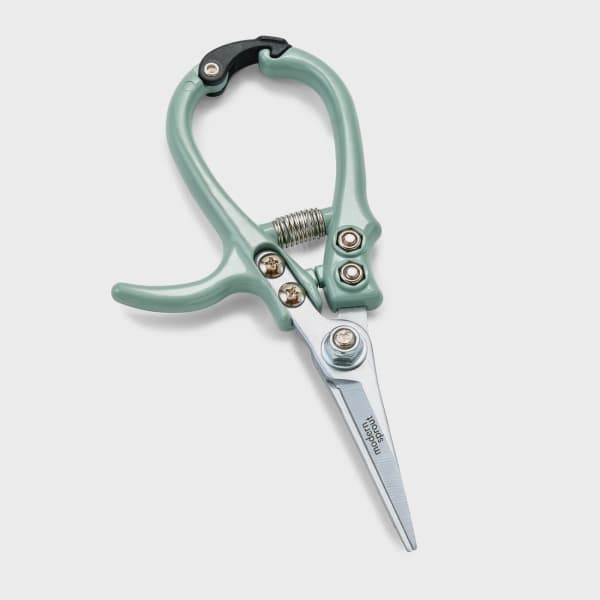 Mint green pruning shears with a spring-loaded handle on a white background