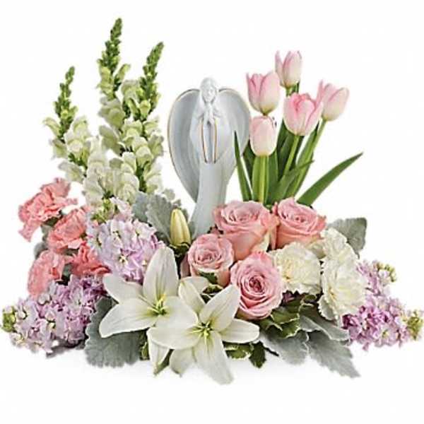 Pink and white floral arrangement with a silver angel figurine
