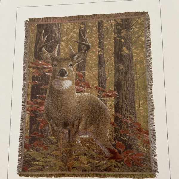 Fringed wall hanging with a deer in an autumn forest