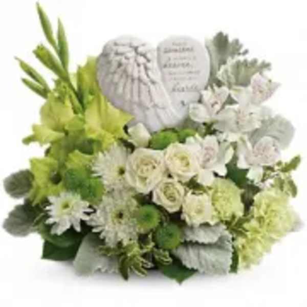 White and green floral arrangement with angel wings and a memorial plaque