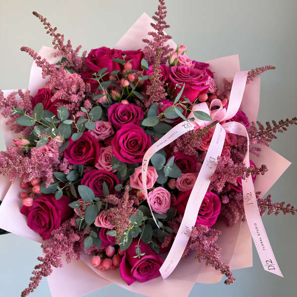 Bouquet of pink and magenta roses with eucalyptus and pink filler flowers