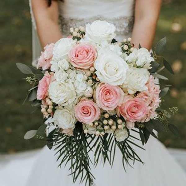 Bride holding a bouquet of pink and white roses