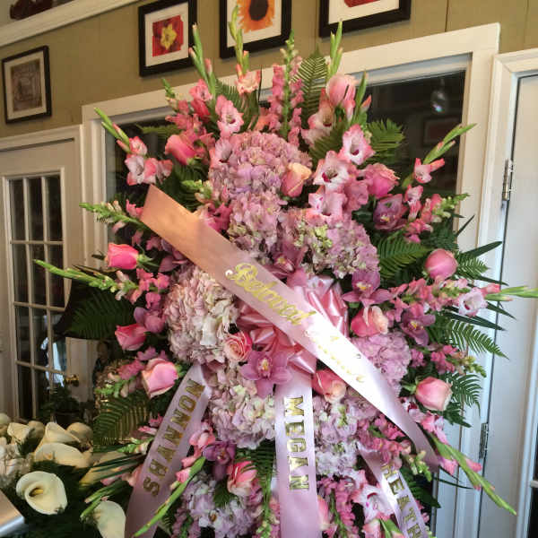 Large pink funeral spray with ribbons and orchids