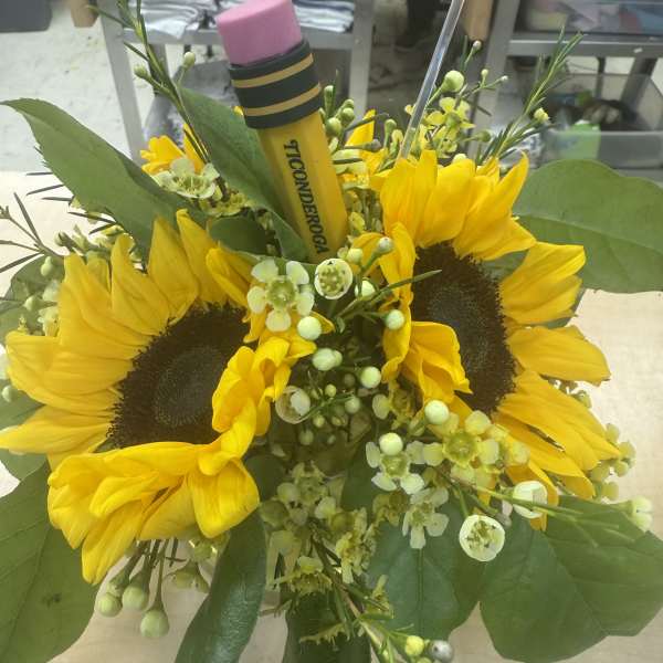 Bouquet of yellow sunflowers with green filler and a pencil topper