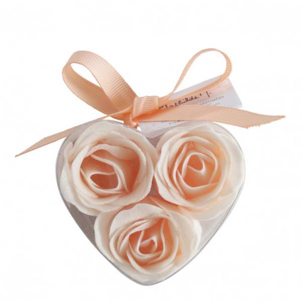 Heart-shaped box with three peach and white roses tied with a ribbon