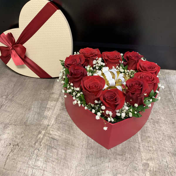 Heart-shaped box of red roses with a ribbon bow