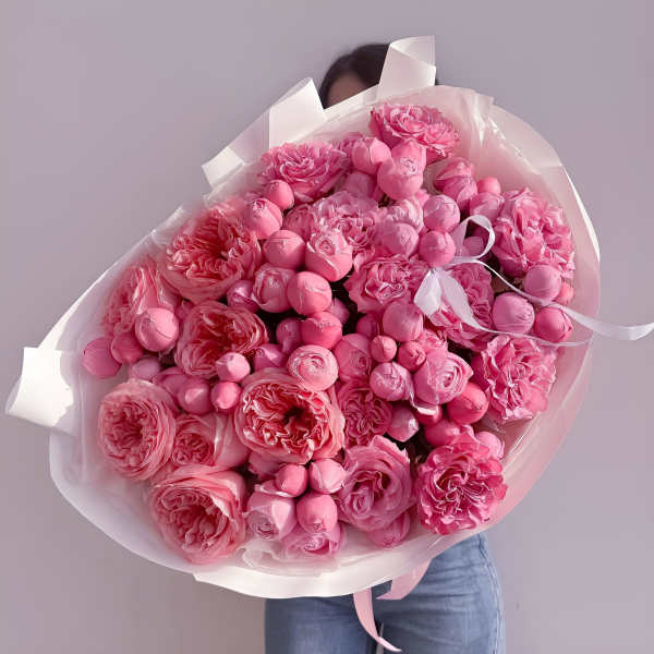Large bouquet of pink roses wrapped in white paper