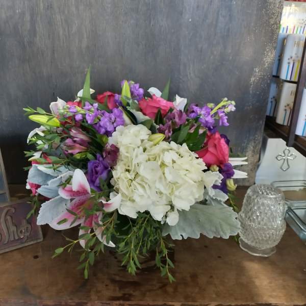 Mixed bouquet with white hydrangea, pink roses, and purple flowers