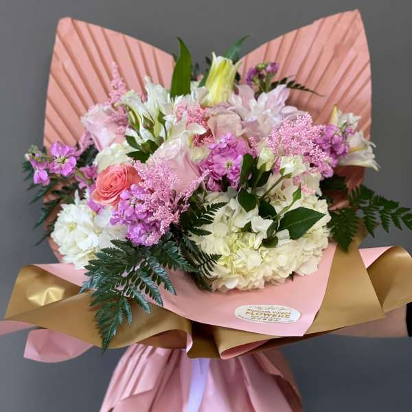Pink and white mixed bouquet wrapped in pink and gold paper
