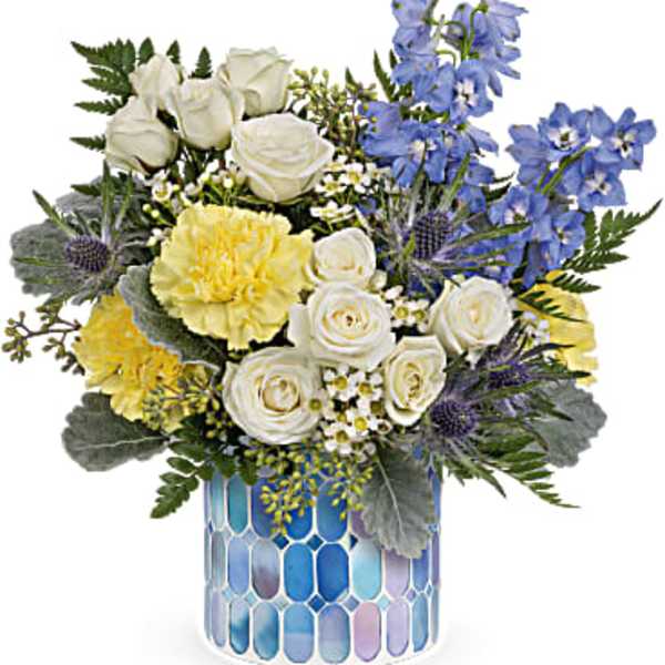 Blue and white floral arrangement in a mosaic glass vase