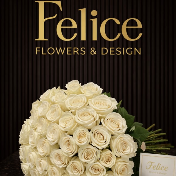 Large bouquet of cream roses with a small card