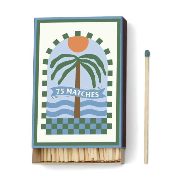 Decorative matchbox with a palm tree design and one match beside it
