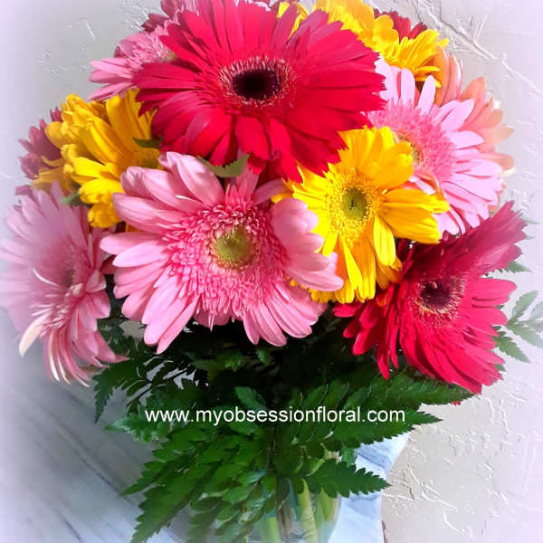 Bouquet of colorful gerbera daisies with green foliage