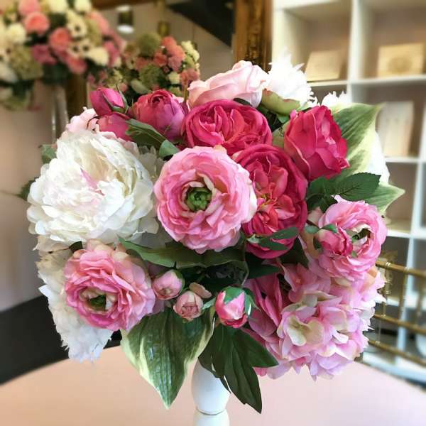 Pink and white flower bouquet in a white vase