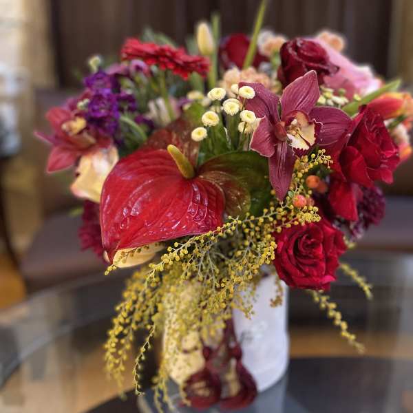 Bouquet of red and pink flowers in a white vase