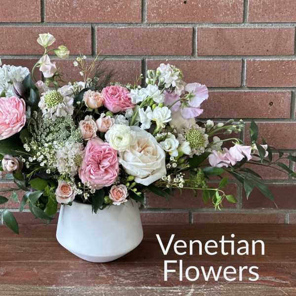 Pink and white floral arrangement in a white vase