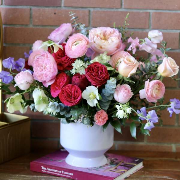 Pink and red mixed bouquet in a white vase