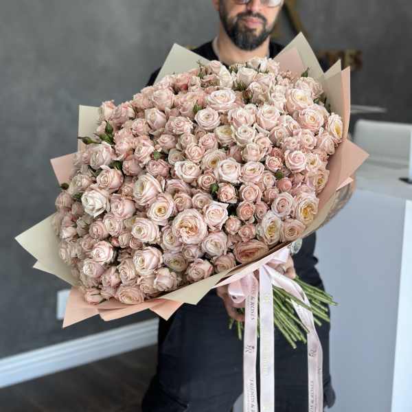 Large bouquet of pale pink spray roses wrapped in blush paper
