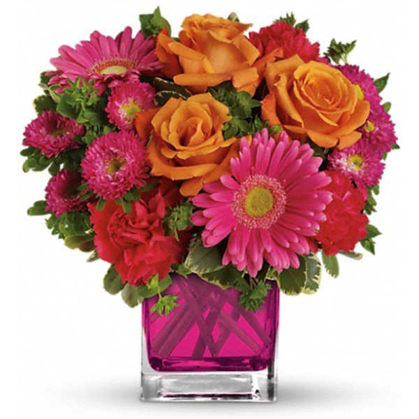 Mixed bouquet of orange roses and pink daisies in a magenta glass vase