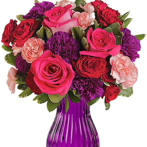 Bouquet of pink, red, and purple flowers in a purple glass vase