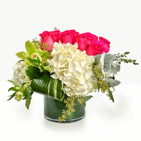 Pink roses and white hydrangeas in a glass vase