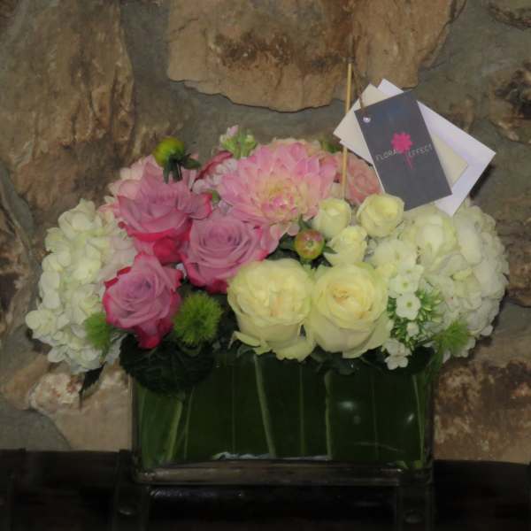 Pink and white flower arrangement in a glass vase