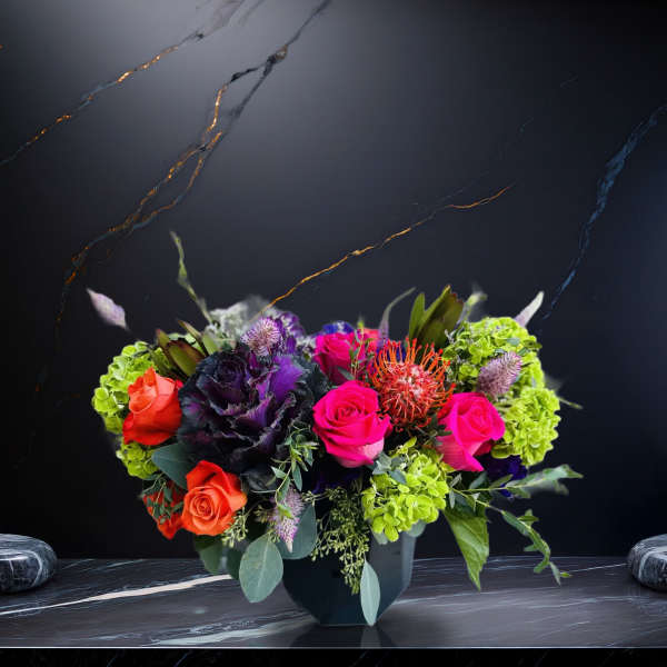 Colorful bouquet of roses and hydrangeas in a dark vase