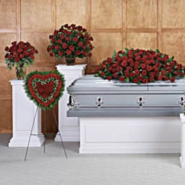Red rose funeral casket spray with matching standing arrangements