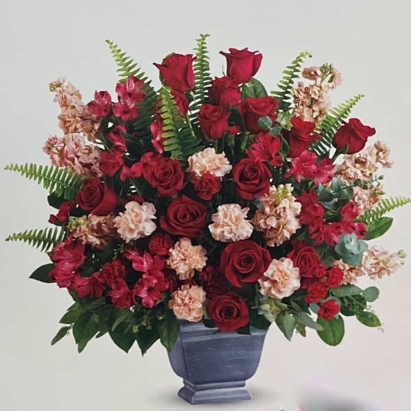 Red roses and pink carnations in a blue vase