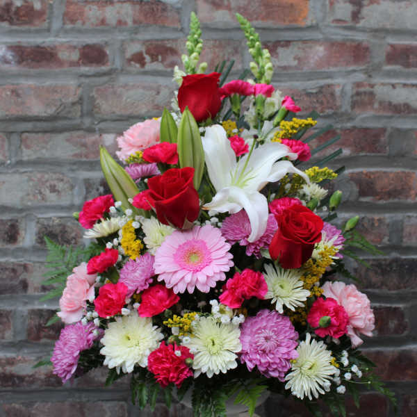 Mixed bouquet with red roses, white lilies, and pink daisies