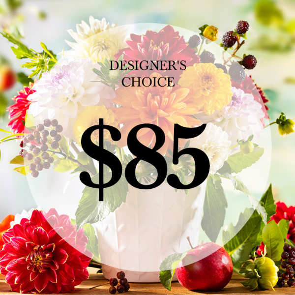 Mixed flower arrangement in a white vase with a $85 price overlay