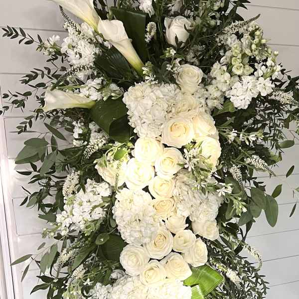 Tall white floral standing spray with roses and calla lilies