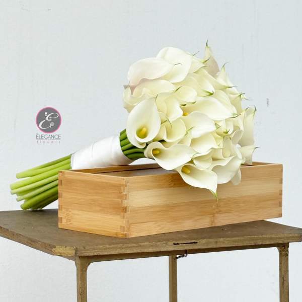 White calla lily bouquet beside a wooden box