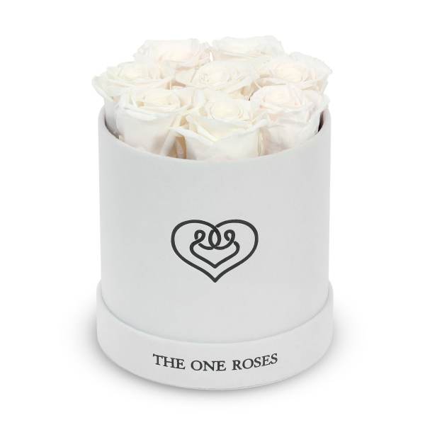 White roses arranged in a round white box with a heart logo