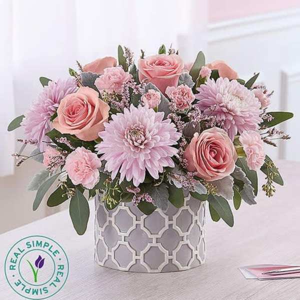 Pink roses and lavender daisies in a patterned vase