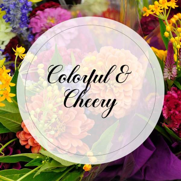 Colorful mixed flower bouquet with a round label reading "Colorful & Cheery"