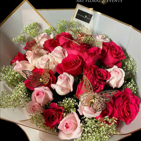 Bouquet of red and pale pink roses with butterfly picks