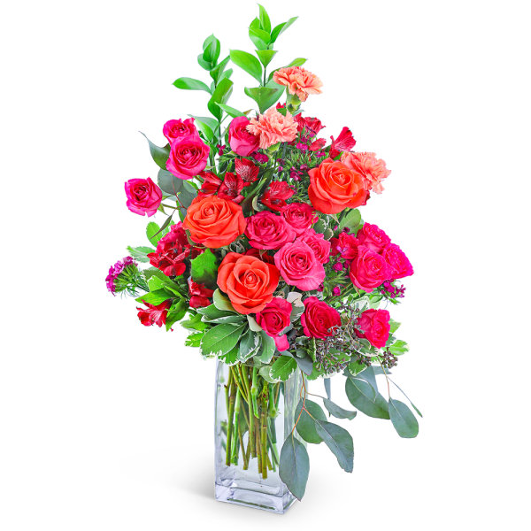 Pink and orange roses in a clear glass vase