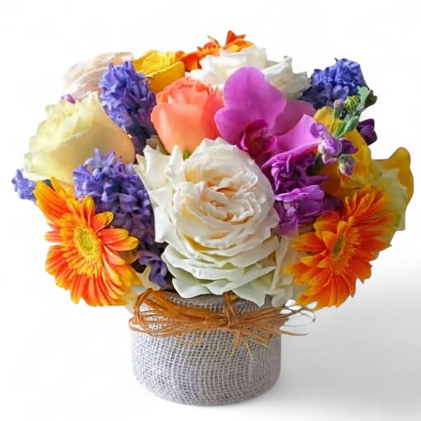 Colorful bouquet of mixed flowers in a burlap-wrapped container