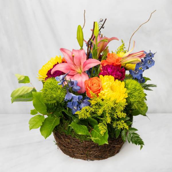 Colorful mixed flower arrangement in a wicker basket