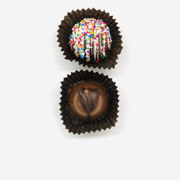 Two assorted chocolate truffles in brown paper cups on a white background