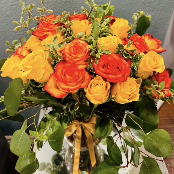 Bouquet of red and yellow roses in a glass vase