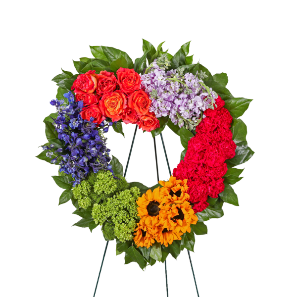 Colorful floral wreath on a stand with roses, hydrangea, and sunflowers