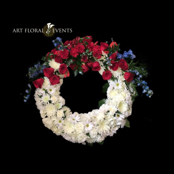 Circular floral wreath with red roses and white daisies on a black background