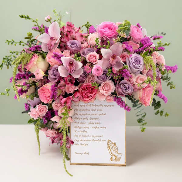 Pink and lavender floral arrangement on a card box with a praying hands illustration