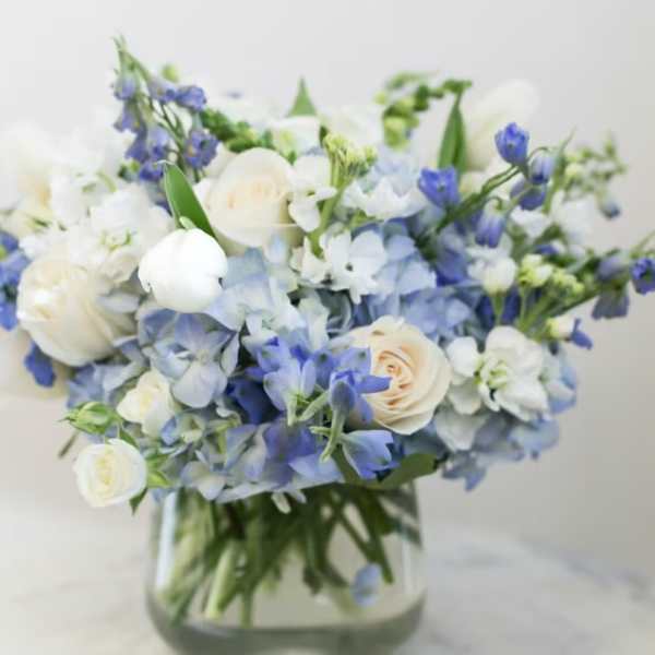 Blue and white bouquet in a clear glass vase