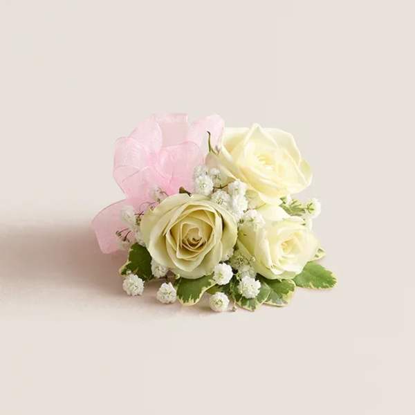 Small bouquet of cream roses with pink wrapping